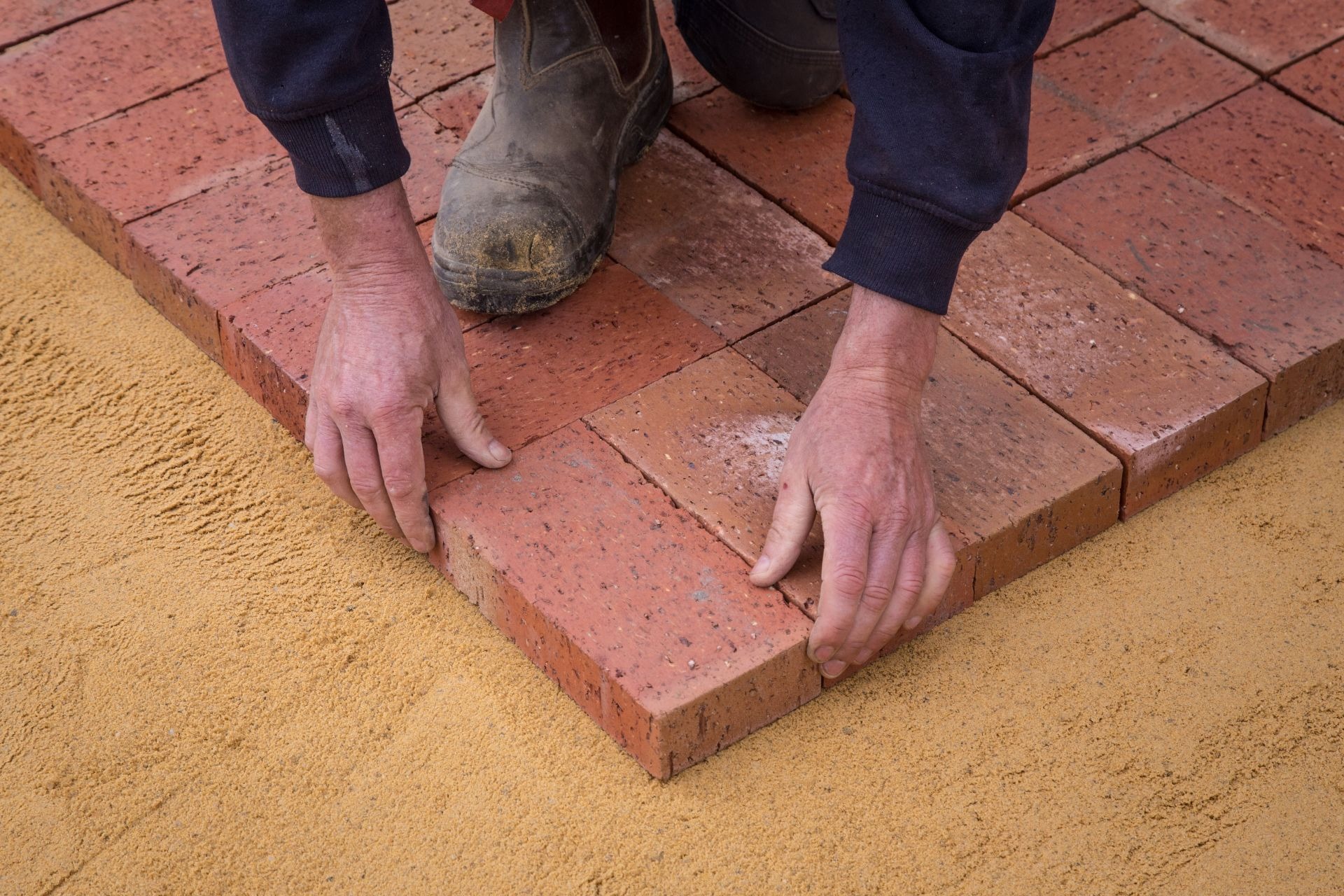 an image of a man laying bricks